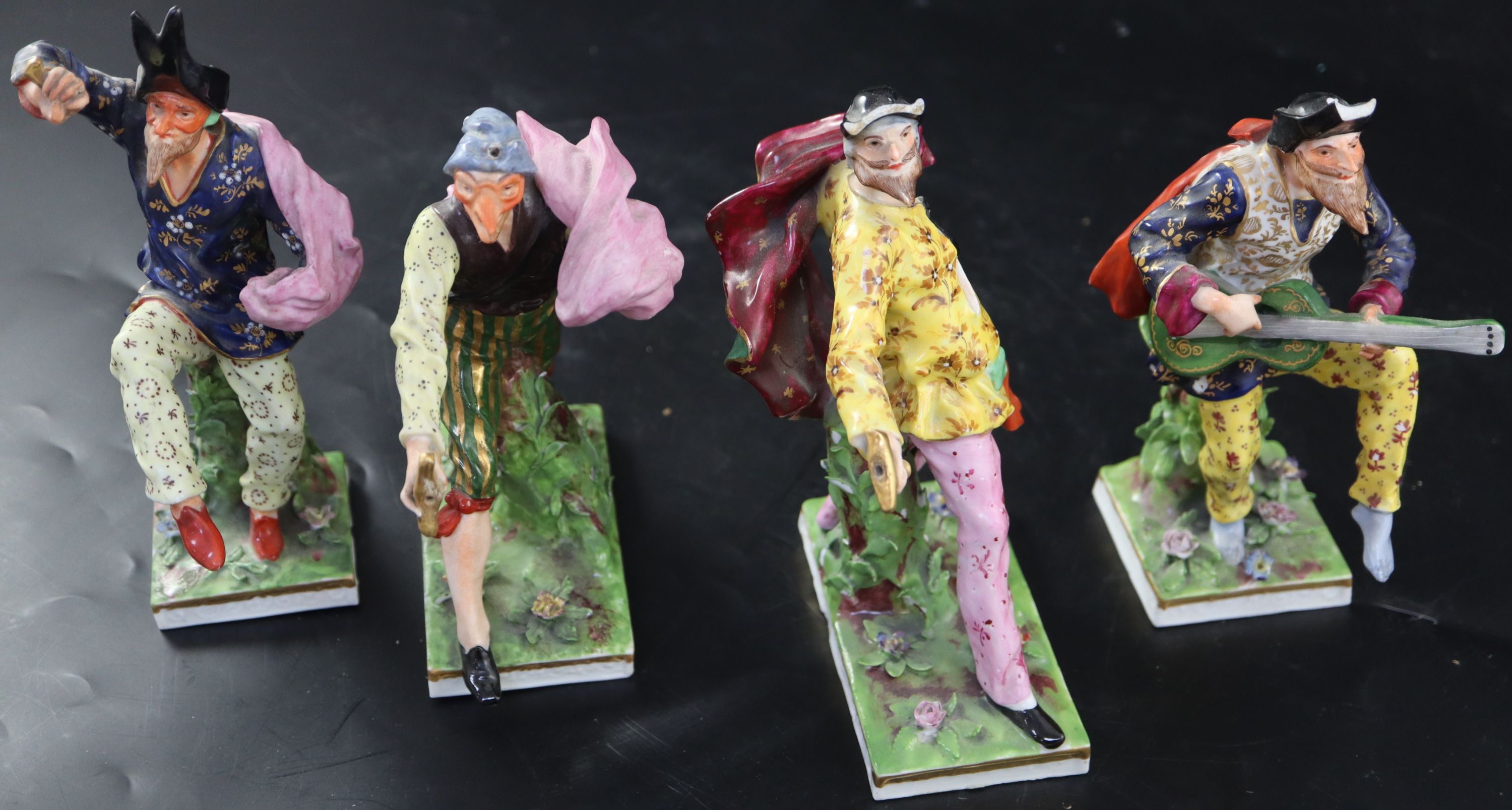 A set of four Continental porcelain Derby-style Comedia del Arte figures, largest 18.5cm